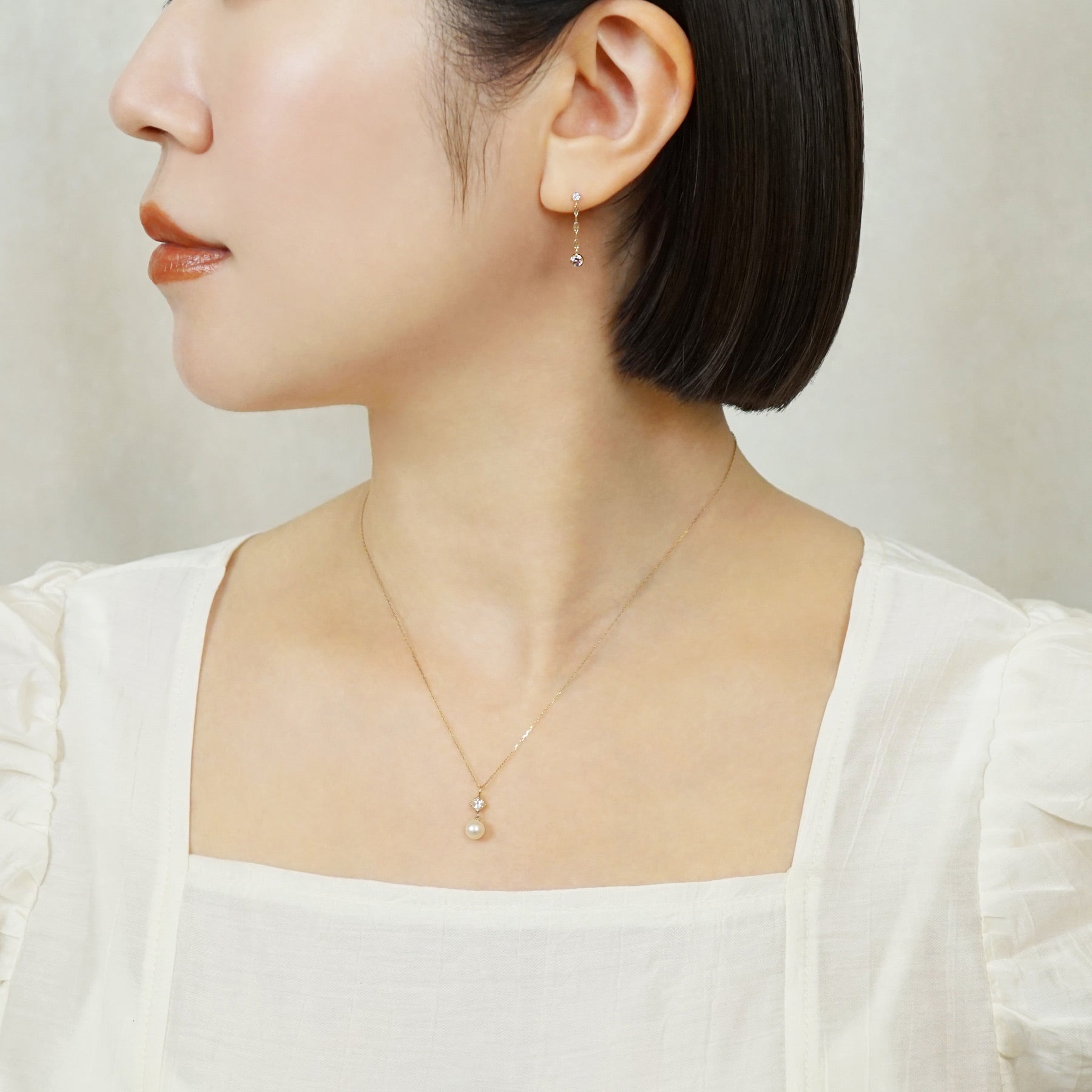 10K Petal Chain Dangle Earrings (Yellow Gold) - Model Image