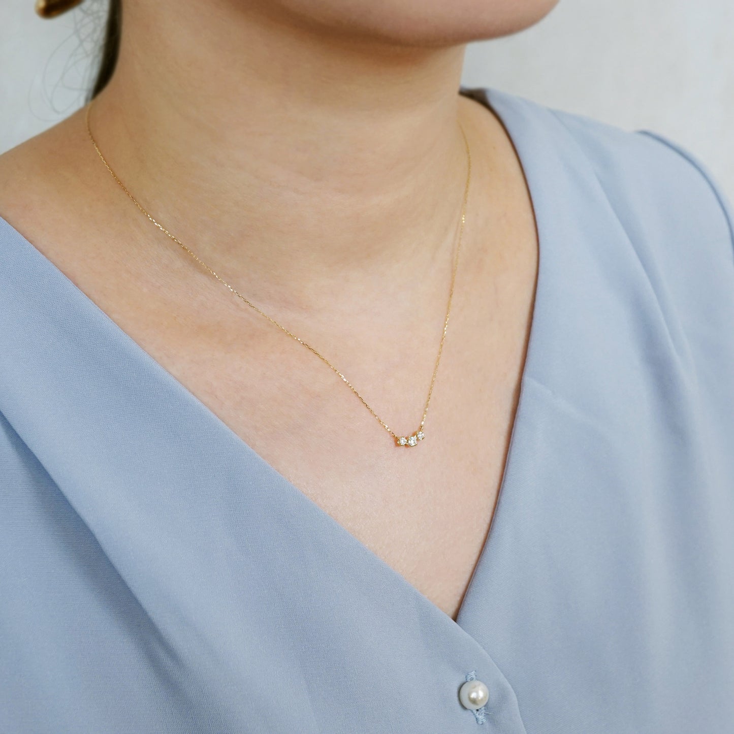 10K Moissanite Trilogy Necklace (Yellow Gold) - Model Image