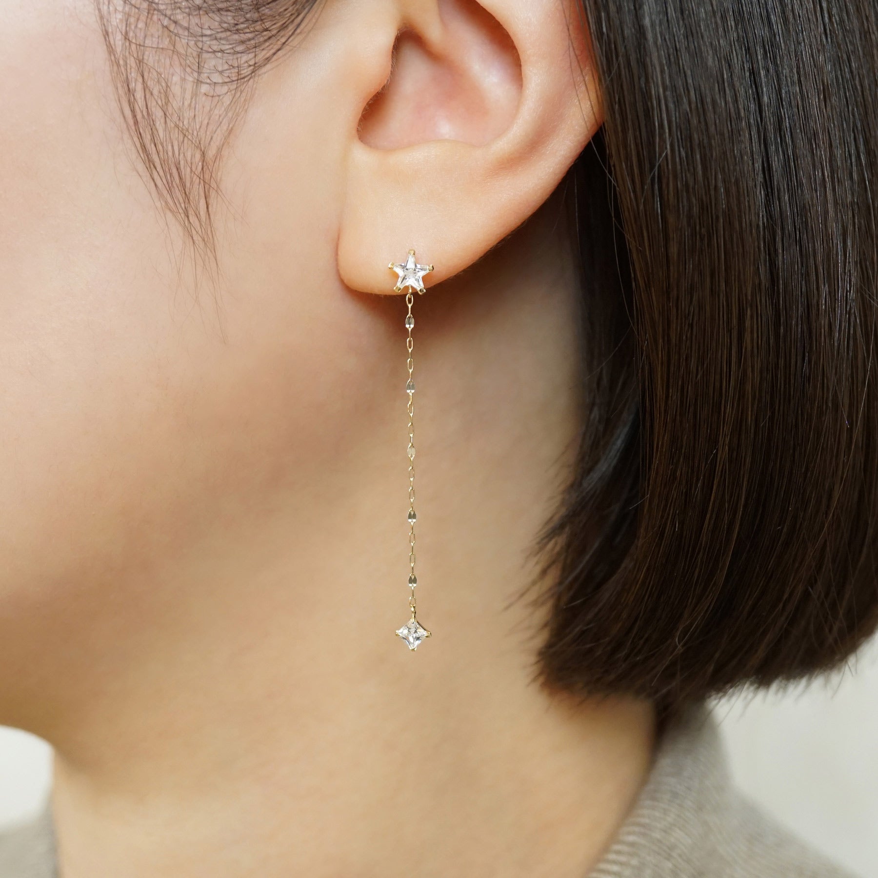 10K Star Long Dangle Earrings (Yellow Gold) - Model Image