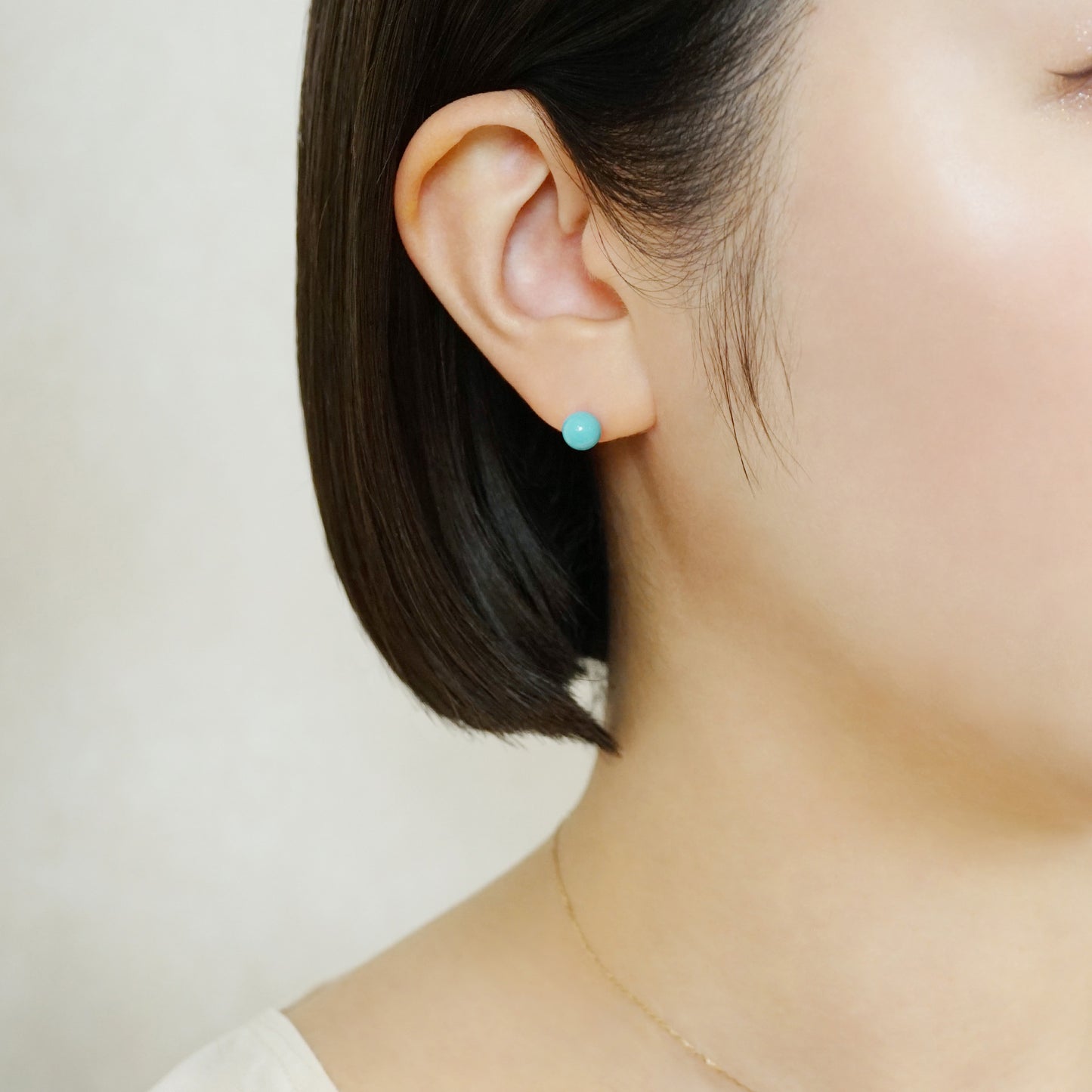 Turquoise Color Ball Ceramic Post Earrings - Model Image