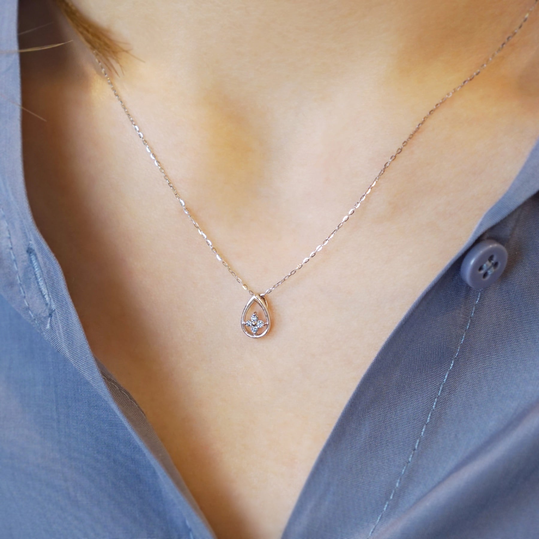 10K White Gold Ice Blue Diamond Dew Drop Clover Necklace - Model Image